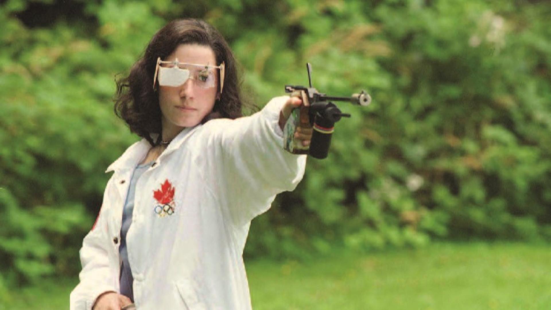 Kim Eagles takes aim with an air pistol and safety glasses.